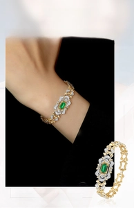 Detail view of vintage emerald bracelet with geometric gold links and zircon inlay