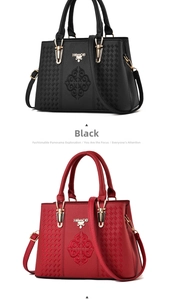 Detail of embroidered faux leather handbags in black and red with gold hardware