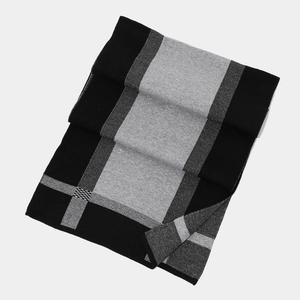 Close-up of black and grey color-block knitted scarf with premium thick texture