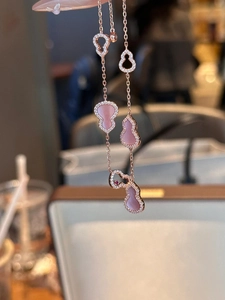 Detail of rose gold hollow gourd charm bracelet with pink stones and zircon stones