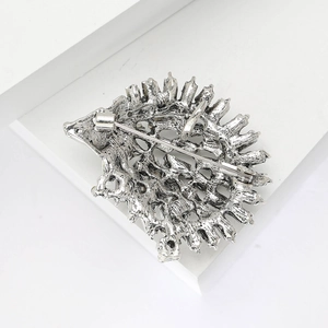 Detailed back view of a silver hedgehog brooch showing the secure metal pin fastener