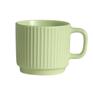 Minimalist light green ceramic mug with vertical stripe texture on white background