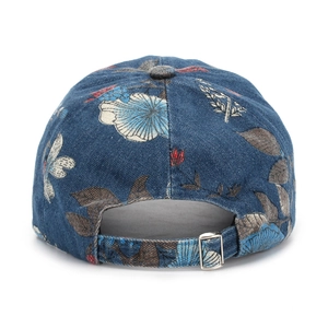 Detail of adjustable silver buckle and floral denim fabric on vintage baseball cap