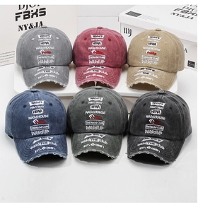 Multiple vintage washed baseball caps with distressed details and graffiti embroidery