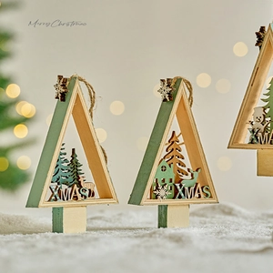 Set of minimalist wooden Christmas tree ornaments with laser-cut deer and house patterns