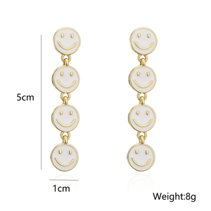 Detail of drop earrings showing 5cm length and white smiley face charm dimensions