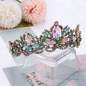 Detail of luxury bridal tiara with colorful crystals and vintage gold floral patterns