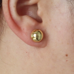 Minimalist 18k gold plated round bead stud earrings showing a smooth metallic finish