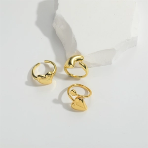 Three 14K gold-plated rings in heart, twisted, and beaded designs on white background