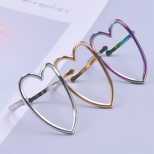 Three-piece stainless steel open heart ring set in silver, gold, and rainbow finishes