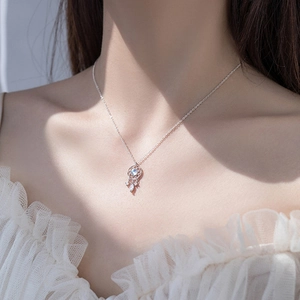 Close-up of S925 silver moonstone dreamcatcher necklace worn on woman's collarbone