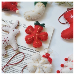 Detail view of handmade wool felt Christmas ornaments with star embroidery and stitching
