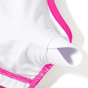 Detail view of white high-elastic fabric with pink trim and built-in chest pad pocket