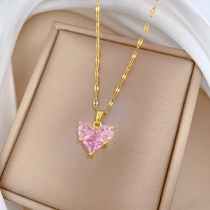 Detailed close-up of a luxury pink heart zircon pendant on a gold-plated titanium steel chain
