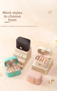 Detailed view of portable jewelry boxes in black white pink and mint green leather