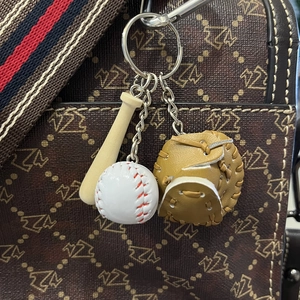 Three-piece baseball keychain set featuring a mini wooden bat, glove, and ball on a bag