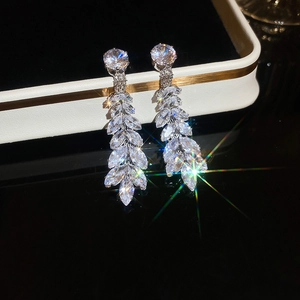 Close-up of elegant silver wheat ear tassel earrings with sparkling zircon gemstones