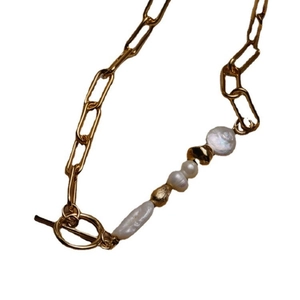 Baroque pearl necklace with gold paperclip chain and OT toggle clasp on white background