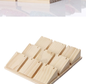 Macro shot of 9-slot wooden necklace display stand with natural grain for jewelry display