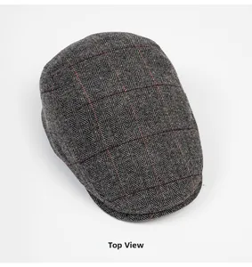 Top view of grey herringbone tweed flat cap featuring subtle red windowpane check pattern