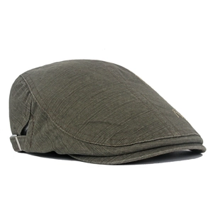 Detail of olive green cotton newsboy cap featuring metal adjustable buckle and stitching