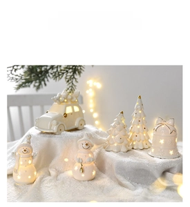Ceramic Christmas ornaments set with LED light featuring snowman and tree on white snow