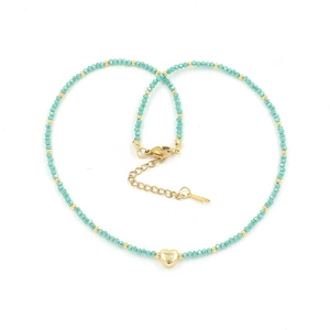 Detail view of colorful crystal beaded necklace with golden heart pendant and clasp