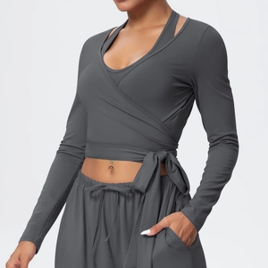 Detail of dark grey yoga set with wrap tie-waist top and drawstring jogger pants
