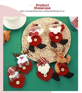 Close-up of plush Christmas ornaments with reindeer and snowman on green background