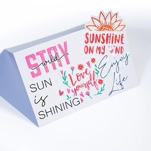 Close-up of holographic motivational vinyl stickers with laser glitter finish for water bottles