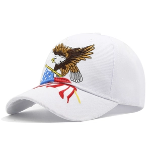 Detailed close-up of white cotton baseball cap with eagle and American flag embroidery