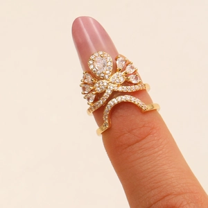 Zircon-studded gold ring with butterfly bow design and teardrop main stone