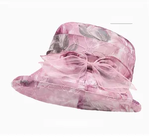 Detailed close-up of pink organza sun hat with floral pattern and large side bow