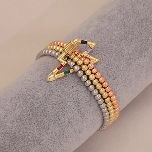 Close-up of three-tone beaded bracelet featuring a colorful gemstone lightning clasp