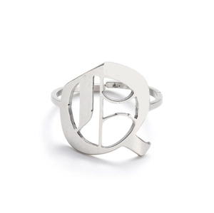 Macro shot of silver stainless steel gothic letter Q ring with detailed carving