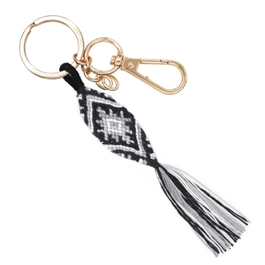 Ethnic handmade woven keychain with diamond pattern and tassel on a gold lobster clasp