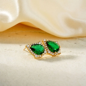 Classic gold drop earrings featuring pear-cut emerald stones with white crystal halo