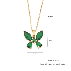Detail of gold butterfly necklace with green glass pendant and stainless steel chain