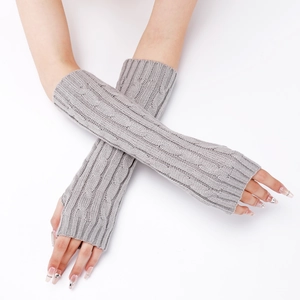 Detail of light grey cable knit fingerless arm warmers with twisted pattern texture