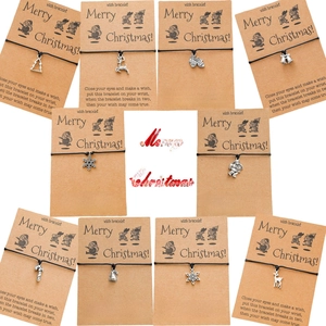 Detailed close-up of Christmas wish bracelets with various alloy pendants on craft cards