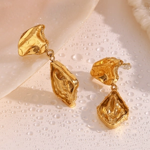 Macro shot of 18K gold plated stainless steel earrings with fluid lava texture design