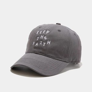 Detailed close-up of grey cotton baseball cap with white KEEP THE FAITH embroidery