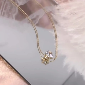 Minimalist gold zircon necklace with a brilliant round pendant in a six-prong setting