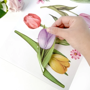 Close-up of easy-to-peel watercolor tulip window sticker being removed from paper