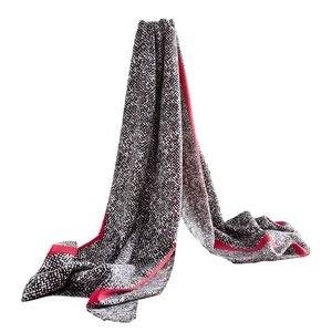 Elegant black and white patterned scarf with bold red borders on a clean white background