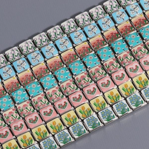 Macro detail of Italian flower and heart charms for stainless steel modular bracelets