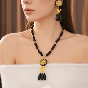 Vintage beaded necklace and earring set with golden flowers and butterfly tassels