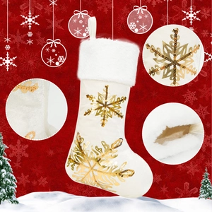 Detail of white velvet Christmas stocking with gold sequin snowflake embroidery decorations