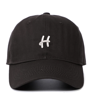 Close-up of white 3D embroidered letter H on black cotton twill baseball cap fabric