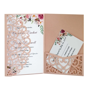 Elegant pink laser-cut floral wedding invitation set with white cards and envelope